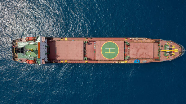 Cargo ship with a helicopter landing aboard. 