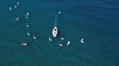 Sailboats in different sizes at sea.