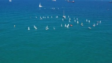 Sailboats in different sizes at sea.