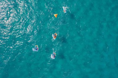 Sailboats in different sizes at sea.