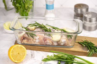 Masada çiğ tavuk budu. Mutfakta tavuk pişirmek. Beyaz arka planda çiğ tavuk budu..