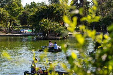 Boats with oars on the pond in the park Ciutadella, Barcelona, Spain