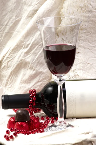 Chocolate with wine bottle and glasses — Stock Photo, Image