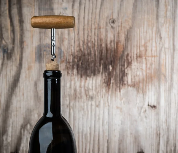 Bottle of wine and corkscrew — Stock Photo, Image