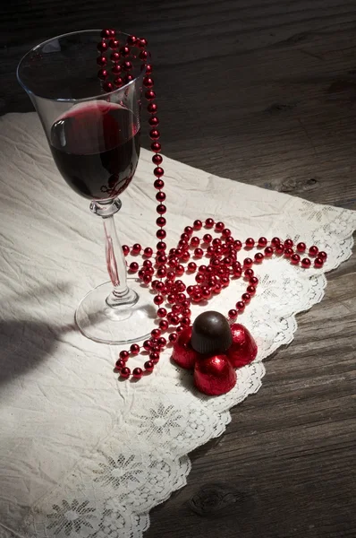 Glass of wine and chocolates — Stock Photo, Image