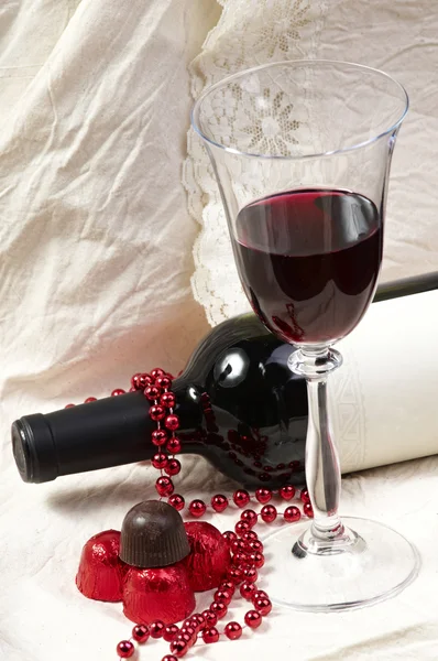 Chocolate with wine bottle and glasses — Stock Photo, Image