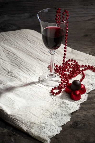 Glass of wine and chocolates — Stock Photo, Image