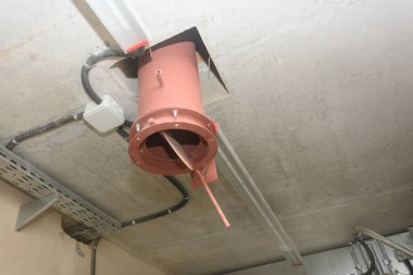 Pipe in ceiling of the room. Forced exhaust ventilation in industry. Close-up, selective focus.
