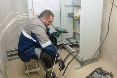 Establishing the connection of cable gland for connection to electrical networks. Electrical engineer at work.