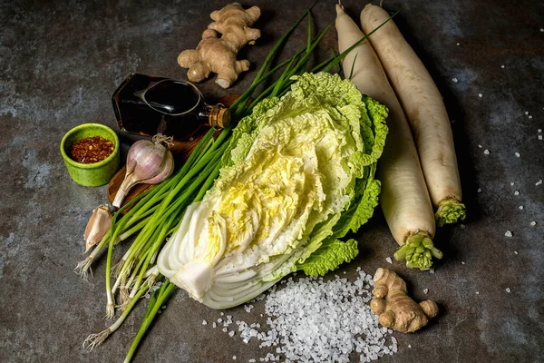 Napa cabbage or Chinese cabbage. Fresh ripe chinese cabbage on a stone table, top view. Place for text, cabbage cut and whole.