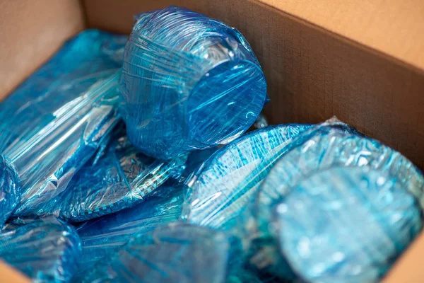 Am Boden eines Kartons sind Gläser mit blauem Wickelnylon umwickelt. Gläser in einer Schachtel verpackt. Ansicht von oben. Flach lag er. Kopierraum — Stockfoto