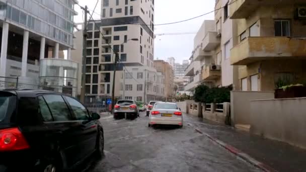 Tel Aviv Yafo, Israel - 17 de diciembre de 2021: Inundaciones de lluvia debido al calentamiento global. El centro de la ciudad se inunda después de tener lluvia. Los vehículos viajan por carreteras inundadas. Invierno urbano — Vídeo de stock