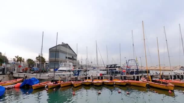 Tel Aviv-Yafo, Israel - December 29, 2021: Panning shot of Jaffa old city harbor with boats, people, and buildings. High quality 4k footage — Stock Video