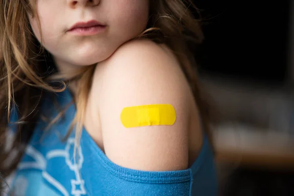 Little girl with a band-aid on her hands, vaccinated against coronavirus infection. Vaccination against COVID-19. Copyspace. High resolution banner — стоковое фото