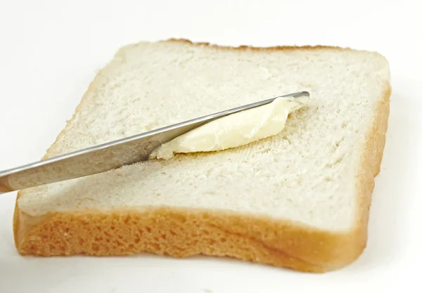 Buttering bread — Stock Photo, Image