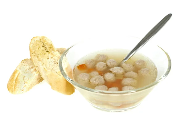 Clear bouillon soup with meatballs, vegetables and garlic bread — Stock Photo, Image