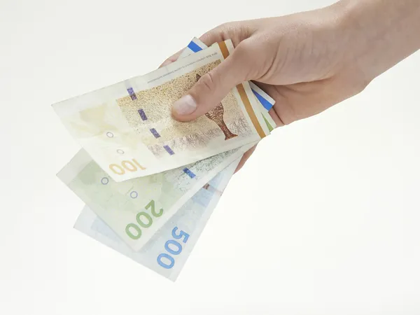 Uma mão segurando moeda dinamarquesa — Fotografia de Stock
