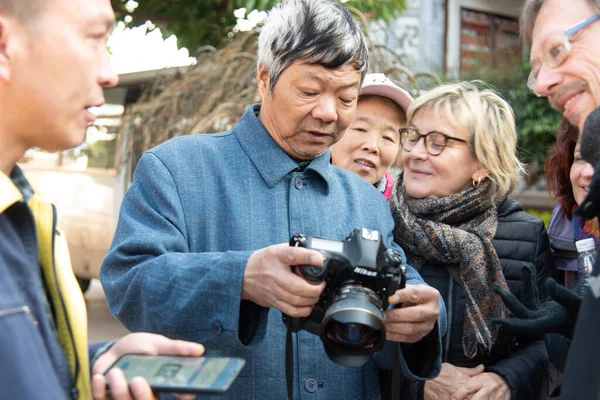Yunnan, Çin Şubat 2019. Batılı turistlerin varlığına şaşıran kırsal bir köyün sakinleri.
