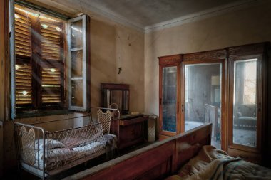 İtalya, 20 Ocak 2021. Antika karyolası ve mobilyası olan bir yatak odası. Terk edilmiş bir evde. urbex