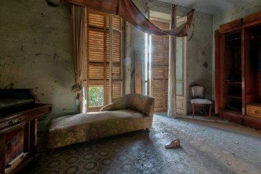 İtalya, 20 Ocak 2021. Terk edilmiş bir evin yatak odasında eski bir şezlong. urbex