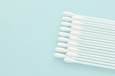 Mavi renkli pastel arka planda beyaz pamuk tomurcukları
