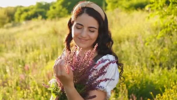 Young Woman Dress Stands Meadow Purple Flowers Her Hands Sunset — Stok video