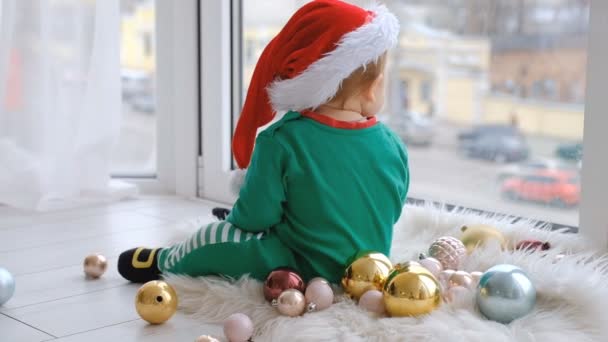 Kid Dressed Santa Sits Window Plays Christmas Decorations Anticipation Holiday — Wideo stockowe