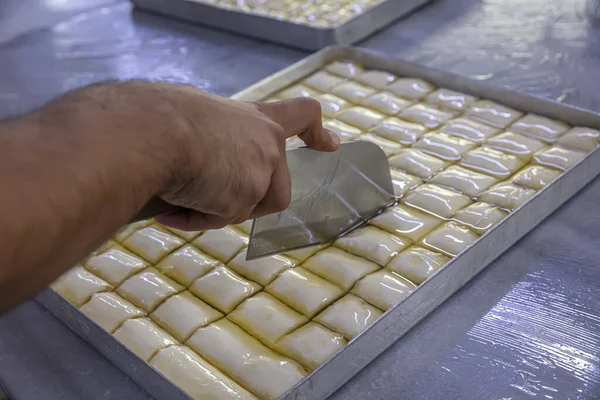 Baklava yapımı. Baklava tatlı hazırlama aşamaları. Şef geleneksel Baklava tatlısı yapıyor..