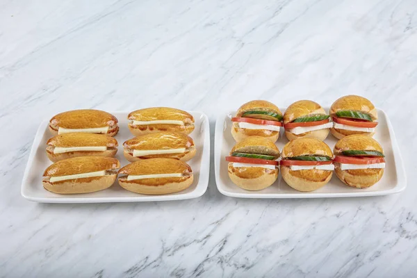 Mini Sandwiches with Cheddar Cheese, Tomato, Cucumber and Cream Cheese. Snacks for parties and picnics.