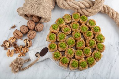 Palace Sarma Baklava with Walnut. Fresh Turkish baklava on a baking tray. Traditional Turkish dessert, also known as Baklava or Saray Sarma.