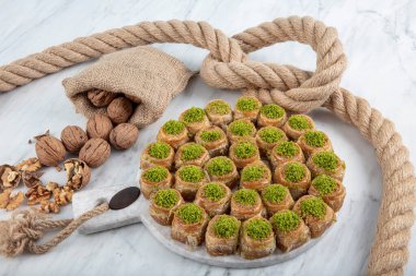 Palace Sarma Baklava with Walnut. Fresh Turkish baklava on a baking tray. Traditional Turkish dessert, also known as Baklava or Saray Sarma.