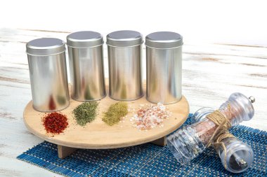 Spices on a pantry shelf. Spices in tin cans.