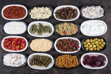 Akdeniz aperatif konsepti. Geleneksel Türk mutfağı. Pancar, zeytin, humus, dolma biber, turşu, dolma yaprak, kavrulmuş biber ve kızarmış yumurta ile Orta Doğu mezeleri..