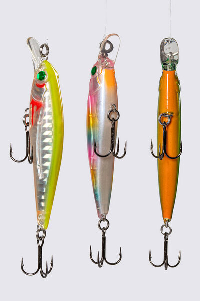 Fishing Lure (Wobbler) fishing temptations on white background. Many Fishing Spinning, fake bait, artificial lure. Colection of Silicon Fishing Twister with Hook and Sinker.