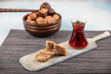 Geleneksel Türk tatlı cevizli baklava ve ahşap masa üzerinde çay. Yemek keki geçmişi. Geleneksel Ceviz Baklava tatlı ve çay konsepti.