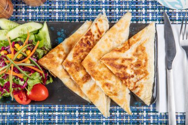 Gozme Türk çöreğidir. Tahta tahtada beyaz peynir ve Türk çayı ile taze pişmiş Türk tortillası Gözleme. Mesaj için yer var. El yapımı Türk geleneksel pastaları