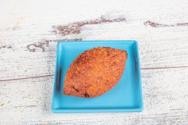 Beyaz ahşap arka planda Kibbeh. Kibbeh, Orta Doğu mutfağında popüler bir yemektir. Doldurulmuş köfteler, falafel, icli Kofta, Quibe. Üst Manzara. Metin için boş alan. Boşluğu kopyala