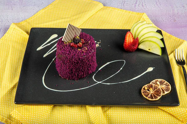 Glazed chocolate cake, one piece, with golden cake on a black plate on a dark black background. One piece cake.