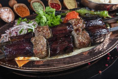Traditional Turkish kebabs. Eggplant kebab, Adana kebab. With tomatoes, peppers, garlic, bulgur pilaf and herbs.Turkish name; patlican kebab, adana kebab.