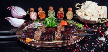 Traditional Turkish kebabs. Eggplant kebab, Adana kebab. With tomatoes, peppers, garlic, bulgur pilaf and herbs.Turkish name; patlican kebab, adana kebab.