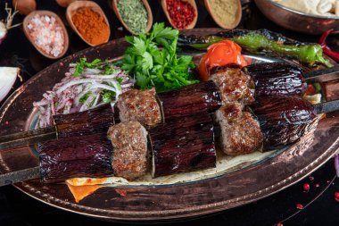 Traditional Turkish kebabs. Eggplant kebab, Adana kebab. With tomatoes, peppers, garlic, bulgur pilaf and herbs.Turkish name; patlican kebab, adana kebab.