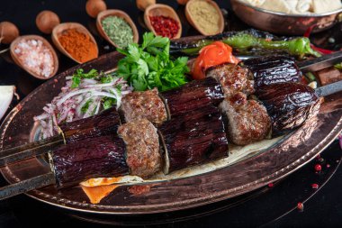 Traditional Turkish kebabs. Eggplant kebab, Adana kebab. With tomatoes, peppers, garlic, bulgur pilaf and herbs.Turkish name; patlican kebab, adana kebab.