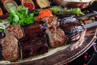 Traditional Turkish kebabs. Eggplant kebab, Adana kebab. With tomatoes, peppers, garlic, bulgur pilaf and herbs.Turkish name; patlican kebab, adana kebab.