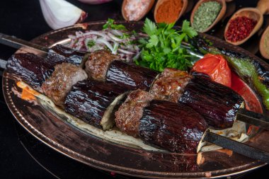 Traditional Turkish kebabs. Eggplant kebab, Adana kebab. With tomatoes, peppers, garlic, bulgur pilaf and herbs.Turkish name; patlican kebab, adana kebab.