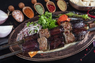 Traditional Turkish kebabs. Eggplant kebab, Adana kebab. With tomatoes, peppers, garlic, bulgur pilaf and herbs.Turkish name; patlican kebab, adana kebab.