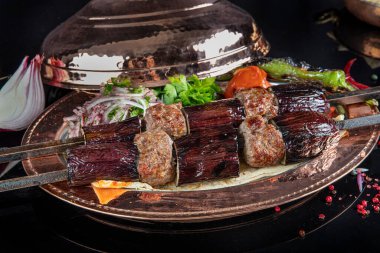 Traditional Turkish kebabs. Eggplant kebab, Adana kebab. With tomatoes, peppers, garlic, bulgur pilaf and herbs.Turkish name; patlican kebab, adana kebab.