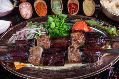 Traditional Turkish kebabs. Eggplant kebab, Adana kebab. With tomatoes, peppers, garlic, bulgur pilaf and herbs.Turkish name; patlican kebab, adana kebab.