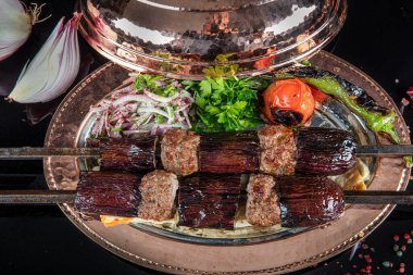 Traditional Turkish kebabs. Eggplant kebab, Adana kebab. With tomatoes, peppers, garlic, bulgur pilaf and herbs.Turkish name; patlican kebab, adana kebab.