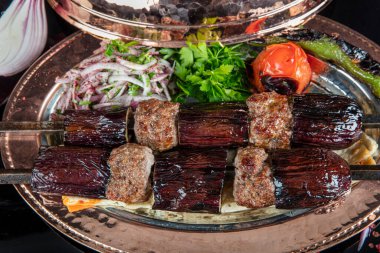 Traditional Turkish kebabs. Eggplant kebab, Adana kebab. With tomatoes, peppers, garlic, bulgur pilaf and herbs.Turkish name; patlican kebab, adana kebab.