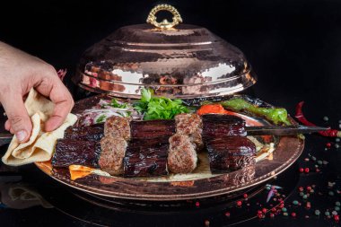 Traditional Turkish kebabs. Eggplant kebab, Adana kebab. With tomatoes, peppers, garlic, bulgur pilaf and herbs.Turkish name; patlican kebab, adana kebab.
